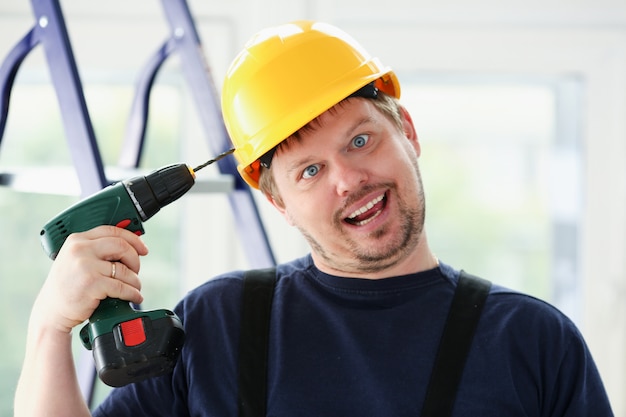 Idiot worker using electric drill portrait