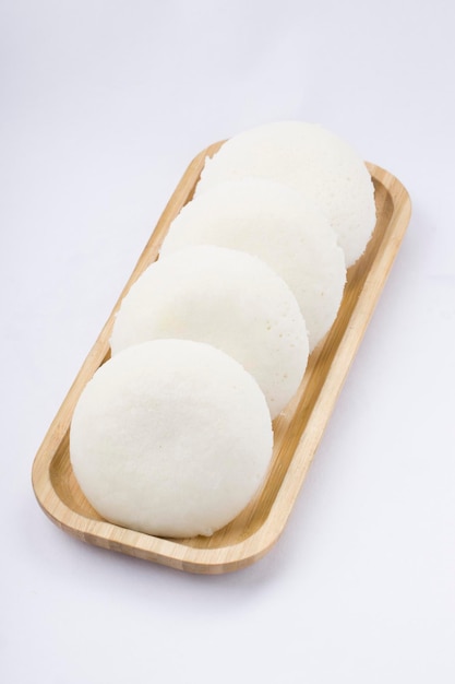 Idly or Idli south Indian main breakfast item which is beautifully arranged in a wooden base