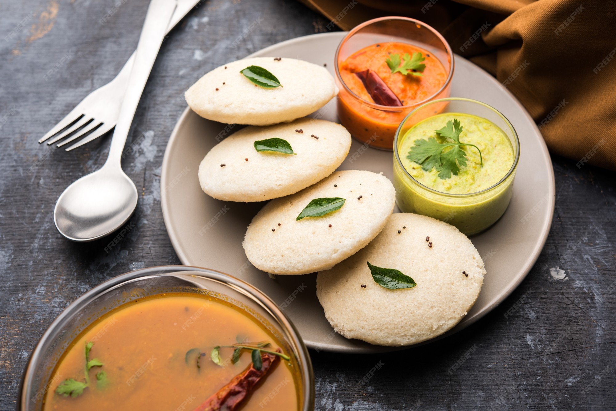 Premium Photo Idly Sambar Or Idli With Sambhar And Green Red Chutney a-view-of-healthy-south-indian-breakfast-food-varieties-served-on-small