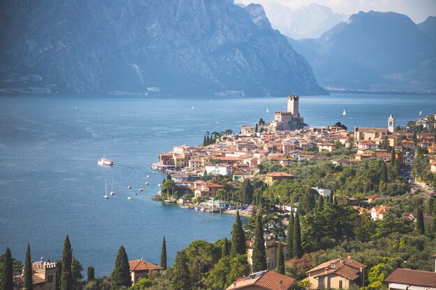 Idyllic coastline scenery in Italy Blue water and a cute village at lago di garda Malcesine