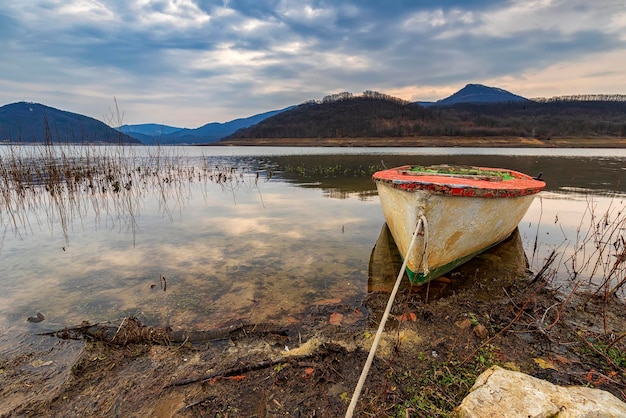 The idyllic mood on a lakeshore with a wooden boat