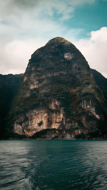 Idyllic shot of a huge mountain covered in vegetation with a body of water at its base