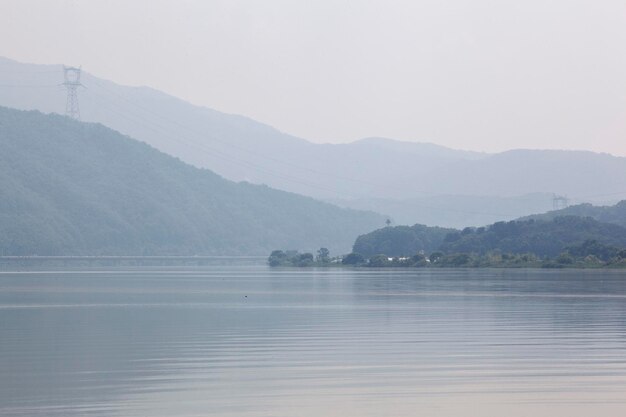 idyllic shot of river and mountains against sky