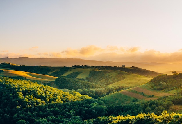 Idyllic shot of tuscany landscape against sky during sunset