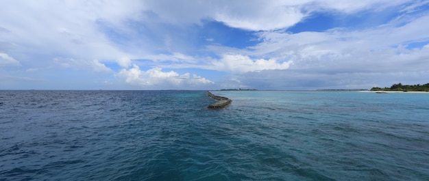 idyllic sunny blue seascape with blue sky and white clouds