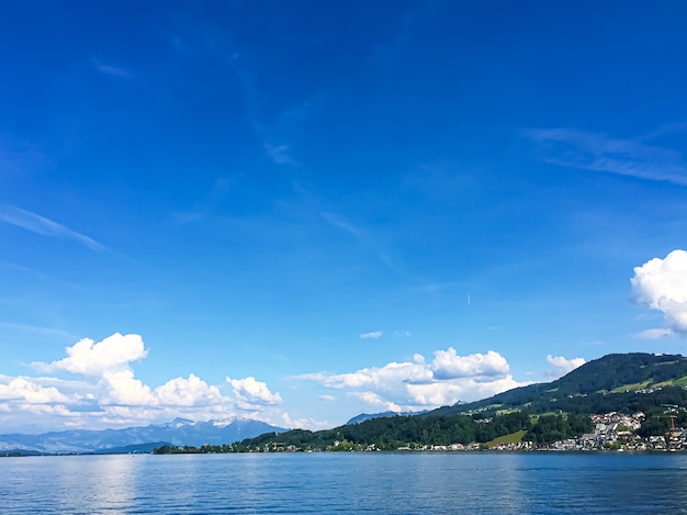 Idyllic swiss landscape view of lake zurich in richterswil switzerland mountains blue water of zuric...