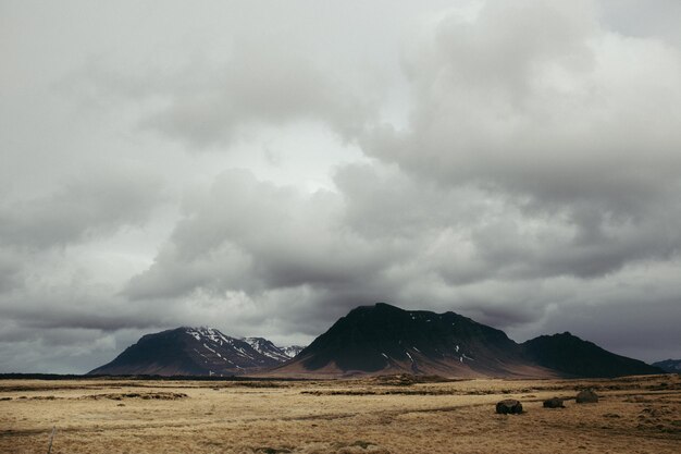 Idyllic view of landscape against cloudy sky