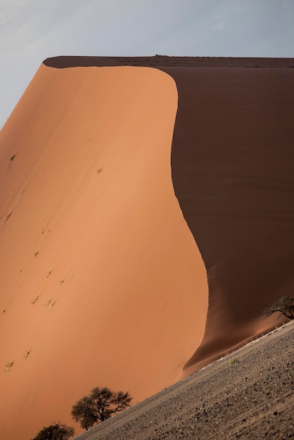 Idyllic view of sand dune against sky