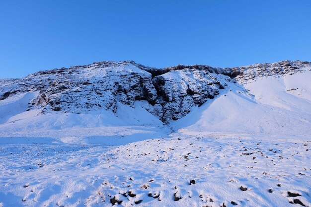 Idyllic view of snowcapped mountain against clear blue sky