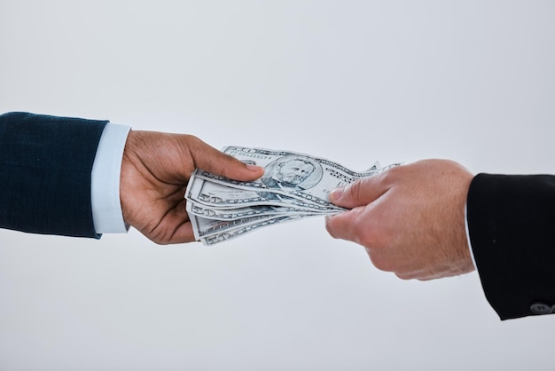 Photo if you want to test character, give him power. shot of a businessman taking money from another man against a grey background.