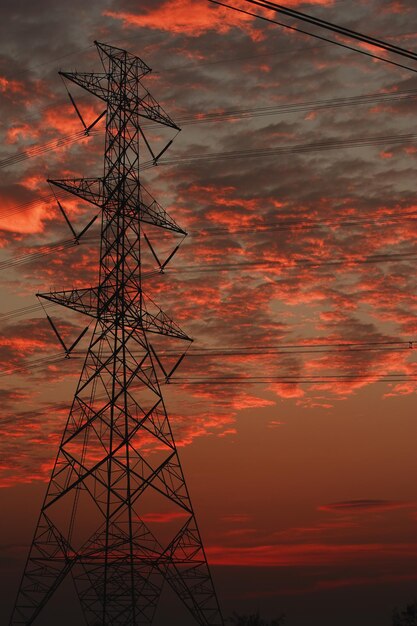 ็igh voltage pole with sun.