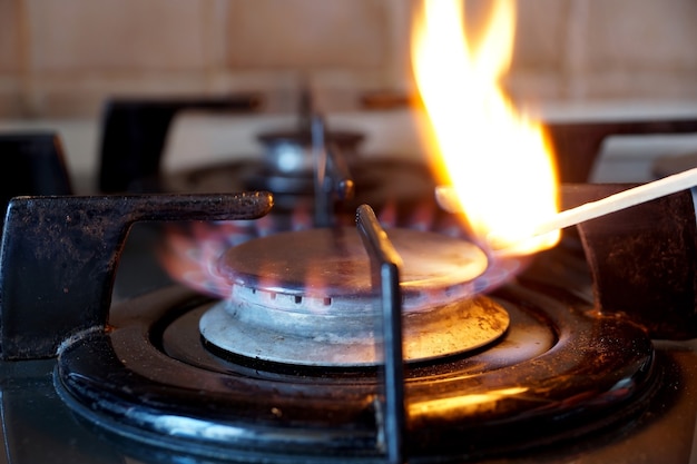 Ignition by a match of a gas ring on the stove