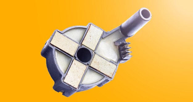 Ignition coil of a distribution type car on an orange background