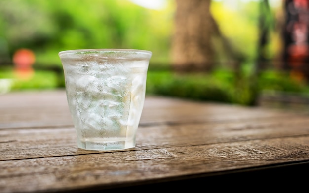 IJs in een glas water op een houten tafel