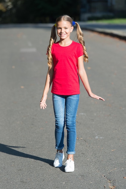 Ik ben gewoon een zomers meisje. Gelukkig meisje zonnig buitenshuis. Mode-look van een klein meisje. Klein meisje met lang haar in casual stijl. Modetrends voor de zomer. Trendy stijl. Kinder kledingkast. Je schijnt door.