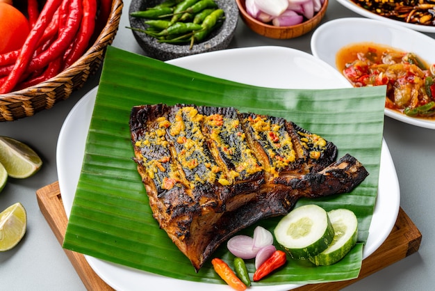 Ikan Pari Bakar or Grilled Sting Ray in chilli curry sauce served on banana leaf