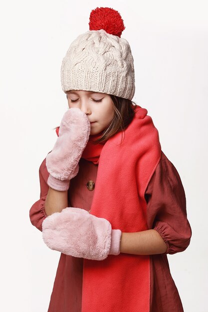 The ill girl in a jacket, a cap, gloves