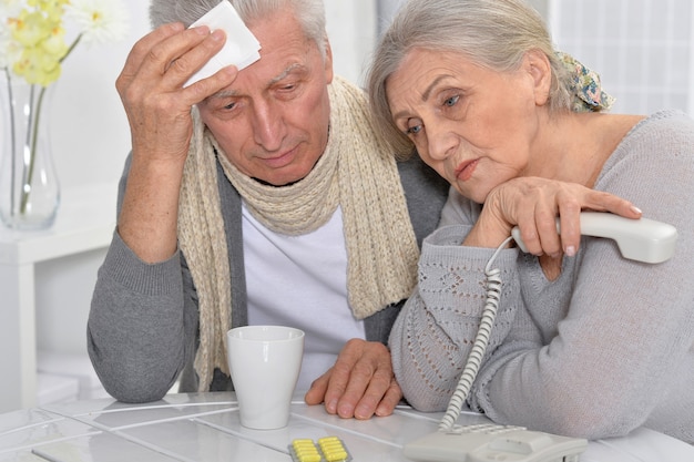 Ill Senior man and caring wife calling phone