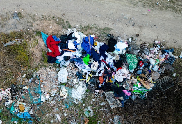 Illegal dump near country road drone view Junk pollution in nature