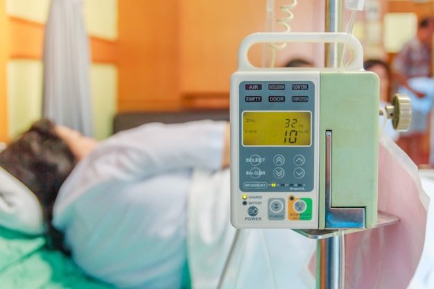 Illness asian old woman lying on sick bed in hospital with infusion pump 