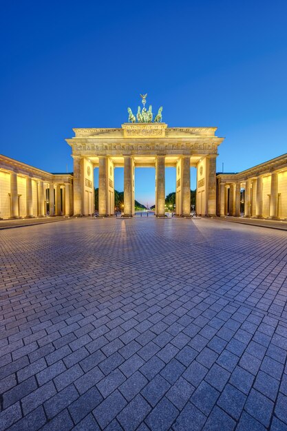 The illuminated brandenburg gate in berlin at dusk with no people