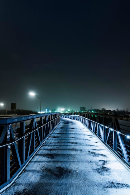 illuminated bridge against sky at night