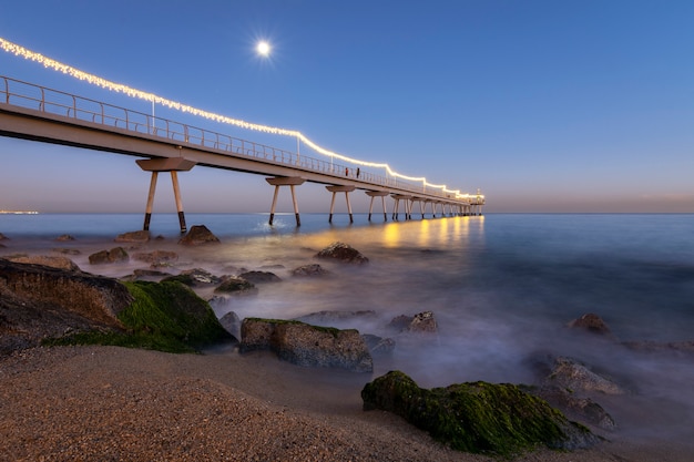 Illuminated bridge on the beach 