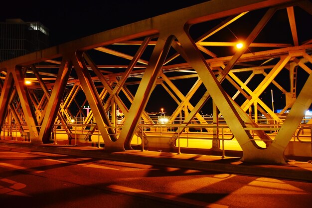 Illuminated bridge at night