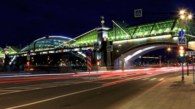 Illuminated bridge over river at night