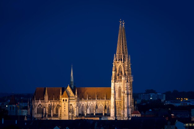 Photo illuminated building against blue sky at night