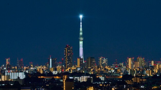 Illuminated buildings against sky at night