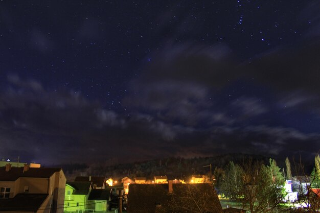 Illuminated buildings against sky at night