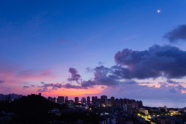 Illuminated buildings against sky at sunset