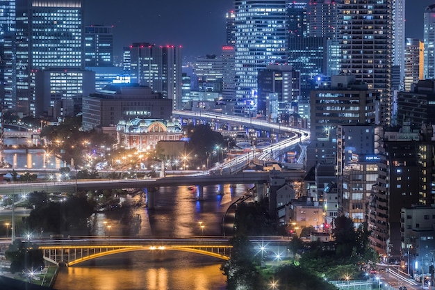 Illuminated buildings and bridge in city