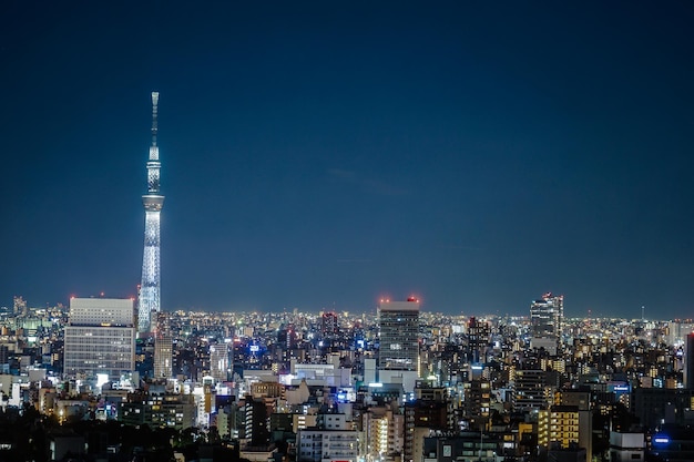 Illuminated buildings in city against sky at night