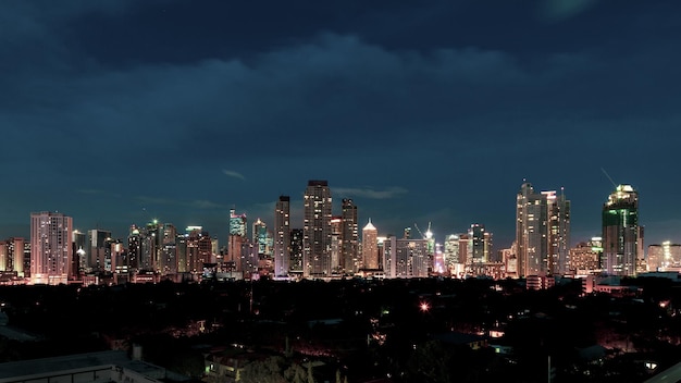 Photo illuminated buildings in city against sky at night