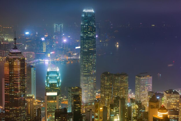 Illuminated buildings in city against sky at night