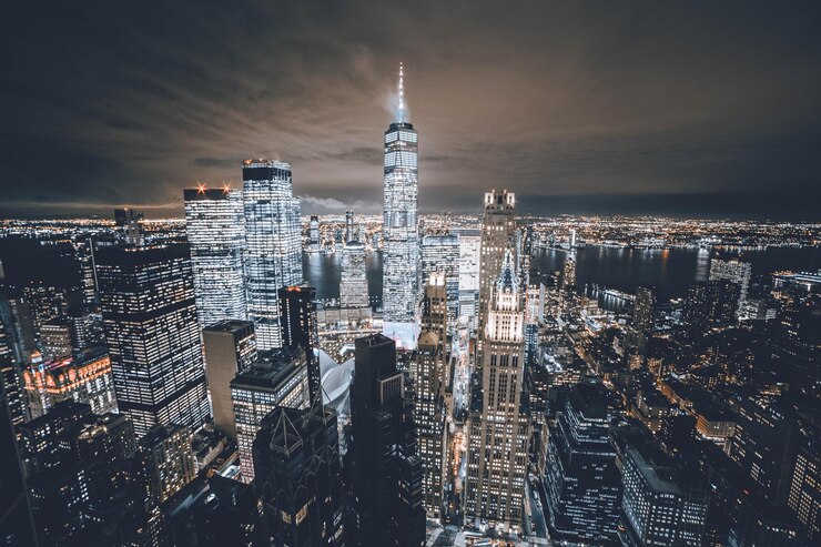 Photo illuminated buildings in city against sky
