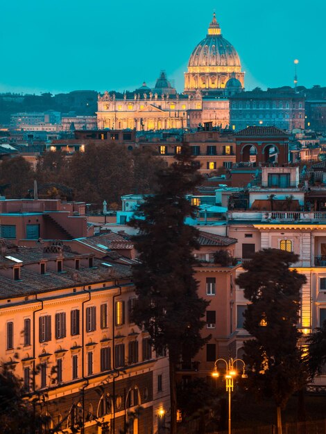 Illuminated buildings in city at dusk in rome