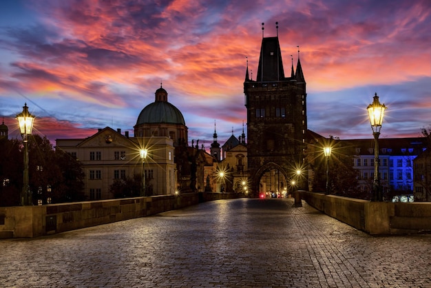 Illuminated buildings in city at sunset