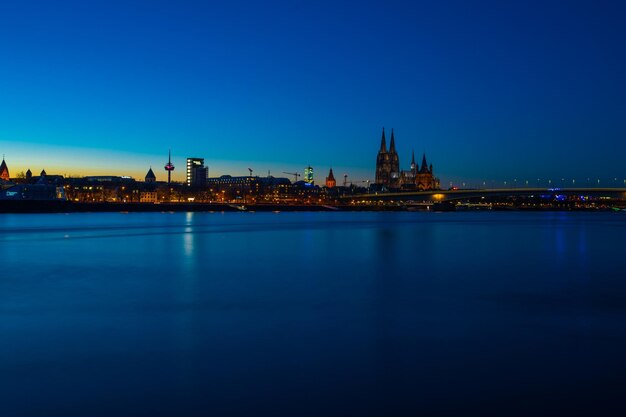 Illuminated buildings in city at waterfront