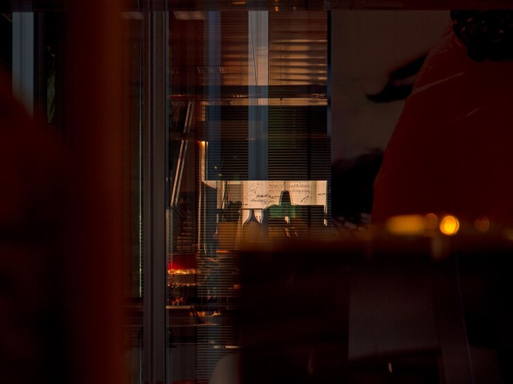 फोटो illuminated buildings seen through glass window at night