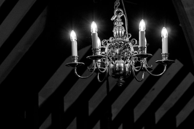 illuminated chandelier hanging against wall