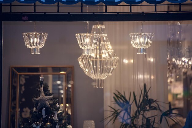 Photo illuminated christmas lights hanging on glass at home