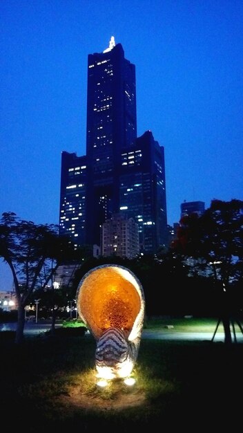 Illuminated city against clear sky at night