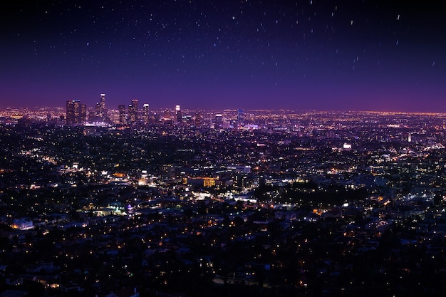 illuminated city against sky at night