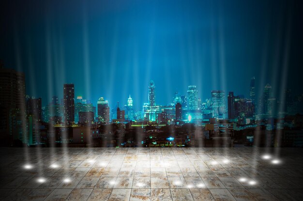 Photo illuminated city buildings against sky at night