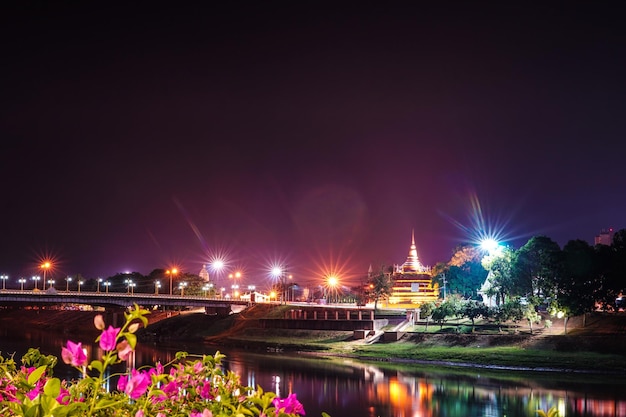 Foto città illuminata dal fiume contro il cielo notturno