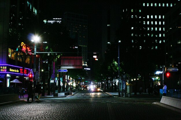 Illuminated city street at night