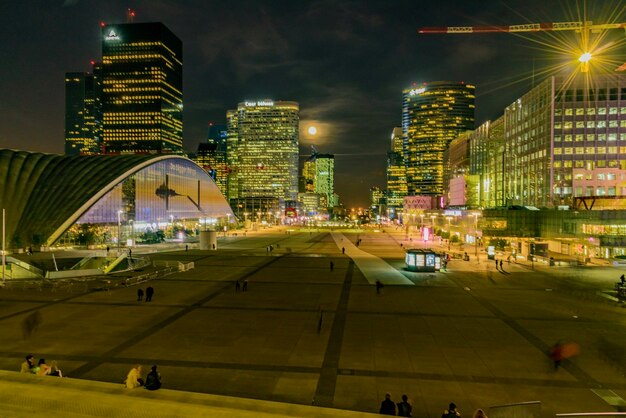 Illuminated cityscape against sky at night